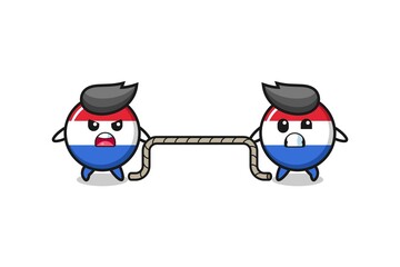 cute netherlands flag character is playing tug of war game