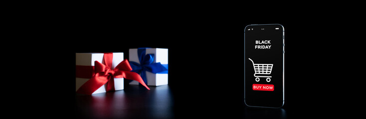 Shopping gift. Internet online app on mobile phone, white gifts box with red ribbon isolated on black background in Black Friday concept. Season sale concept.