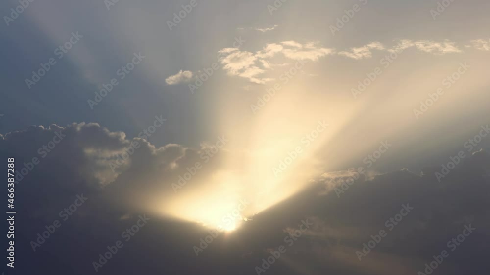 Wall mural beautiful heaven with dramatic light in the evening before sundown light penetrates through the clou