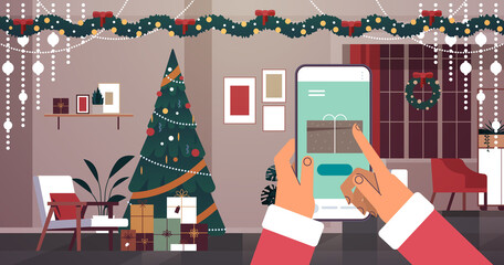 santa claus hands choosing gifts on smartphone screen merry christmas happy new year winter holidays celebration