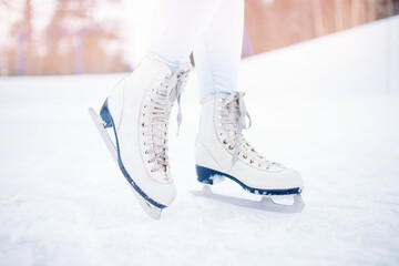 Close-up of women figure skates on ice rink in winter