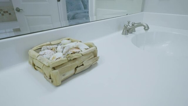 Close up slider shot spotlessly clean on-suite bathroom 