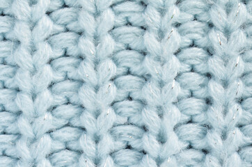Knitted fabric of blue color. Soft focus