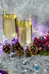 glasses with champagne against the background of New Year's decoration. Christmas table with glasses of champagne. New Years Eve. 