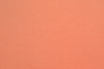 Natural coral-dyed fabric texture background. Close-up of soft cloth backdrop.