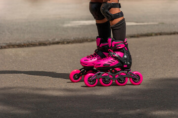 Close-up of person with pink roller skates