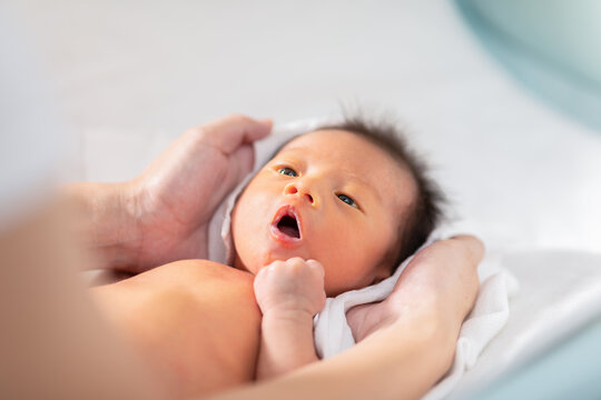 Portrait Mother Put Towel On Her Baby To Get Dry After Bath Comfortable.Newborn Baby Looking Her Mom Rub Her Body Dry With Love.Baby Newborn Care And Mother's Day Concept