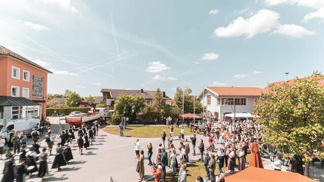 Many people setting up a tradional maypole in Bavaria on Mai 1st.