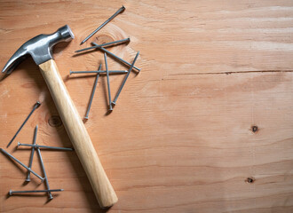 hammer and nails on wooden background