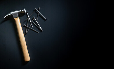 hammer and nails on black background