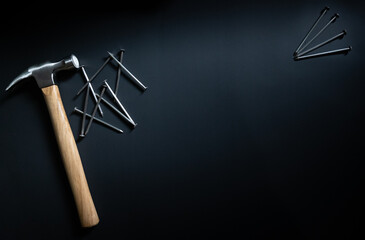 hammer and nails on black background