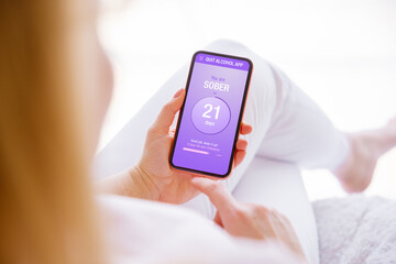 Woman using mobile app to track alcohol consumption and quit drinking
