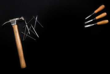 hammer and nails on black background