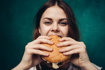 woman eating hamburger fast food snack close-up