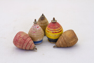 Retro spinning tops made from wood isolated on a clear surface with copy space