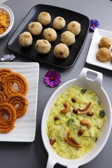 Indian festival food - Diwali Special sweet and salty snacks such as Chakli, Rava laddu, besan ladu, poha chivda, and corn mixture, Namkeen snacks. Diwali Faral from Maharashtra, India. Copy space.