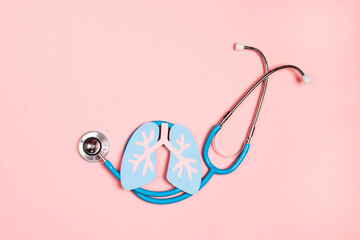 Prevention of pulmonary disease. Lung symbol and stethoscope on a pink background.