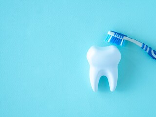 Fototapeta na wymiar Dental concept tooth and brush on a blue background.