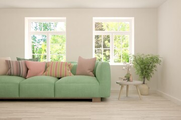 Stylish room in white color with sofa and summer landscape in window. Scandinavian interior design. 3D illustration