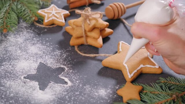 Christmas gingerbread cookies ready to decorate with icing, aromatic cloves, ginger, cinnamon and rich black treacle. Close-up on the table. Stars and gingerbread man. Kids activity. Copy space, card