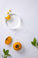 Background Cosmetics with persimmon extract top view. Close-up and white decoration background. The...