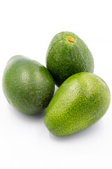 Avocado on a white background. Combined with the shade of ripe avocado. Story format close-up