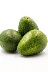 Avocado on a white background. Combined with the shade of ripe avocado. Story format close-up