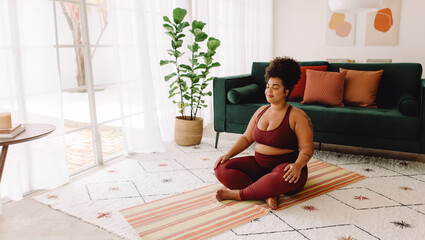Healthy woman practicing yoga meditation at home