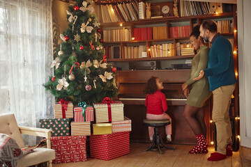 Obraz na płótnie Canvas Mixed race family enjoying Christmastime at home