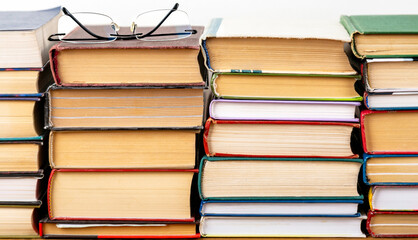 A stack of hardback books.