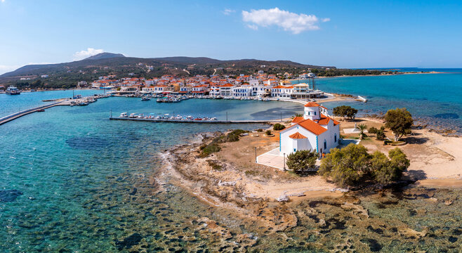 Elafonisos Peloponnese. Greece. Island harbor buildings and Agios Spyridon church, aerial drone view