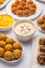 Group of Indian assorted sweets or mithai with diya