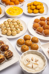 Group of Indian assorted sweets or mithai with diya