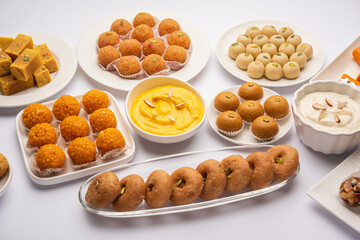 Group of Indian assorted sweets or mithai with diya