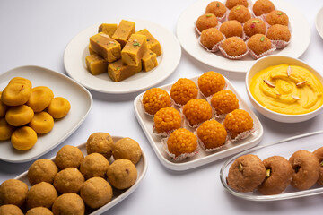 Group of Indian assorted sweets or mithai with diya