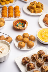 Group of Indian assorted sweets or mithai with diya