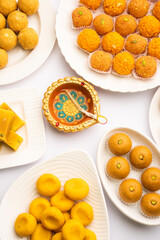 Group of Indian assorted sweets or mithai with diya