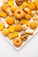 Group of Indian assorted sweets or mithai with diya
