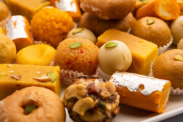 Group of Indian assorted sweets or mithai with diya