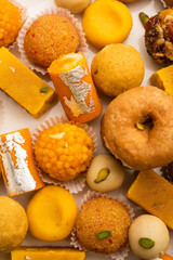 Group of Indian assorted sweets or mithai with diya