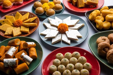 Group of Indian assorted sweets or mithai with diya