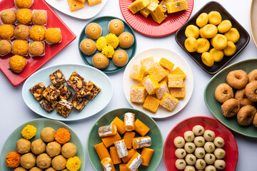 Group of Indian assorted sweets or mithai with diya