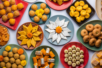 Group of Indian assorted sweets or mithai with diya