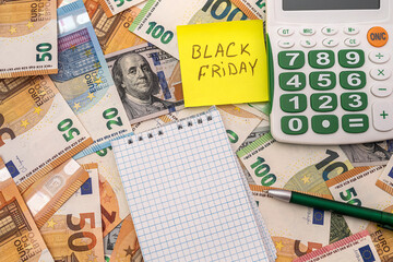 black friday write on memo, dollar and euro money for shopping.