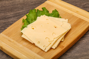 Sliced yellow cheese over board