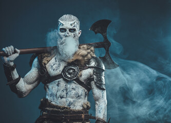 Scary undead from nord with axe in blue background with fog