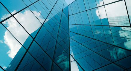 Fototapeta premium business building in city with mirror windows with reflections of blue sky.