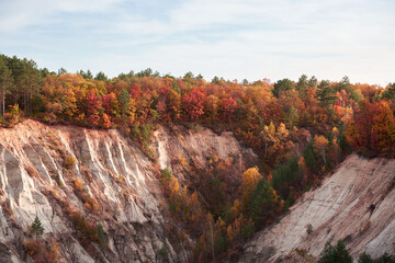 Autumn landscape. Bright and colorful trees at the edge of the cliff. Amur region