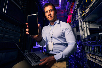 Caucasian IT technician working in server room