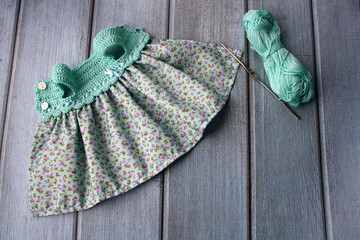 Crochet dress for a doll made of cotton yarn . Home needlework made of thread.